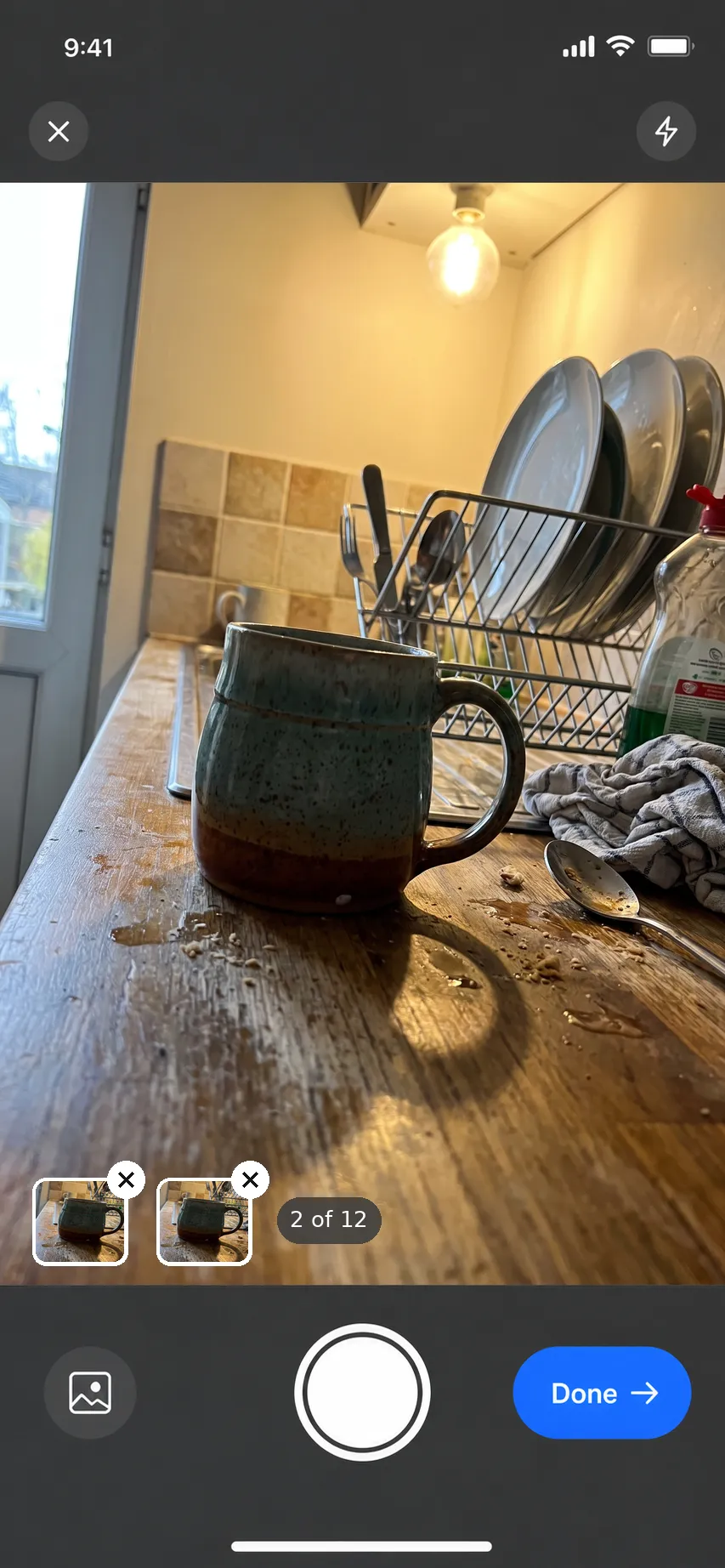 The InHub camera: a quick phone snapshot of a ceramic mug on a cluttered kitchen counter, two shots already taken, and a Done button
