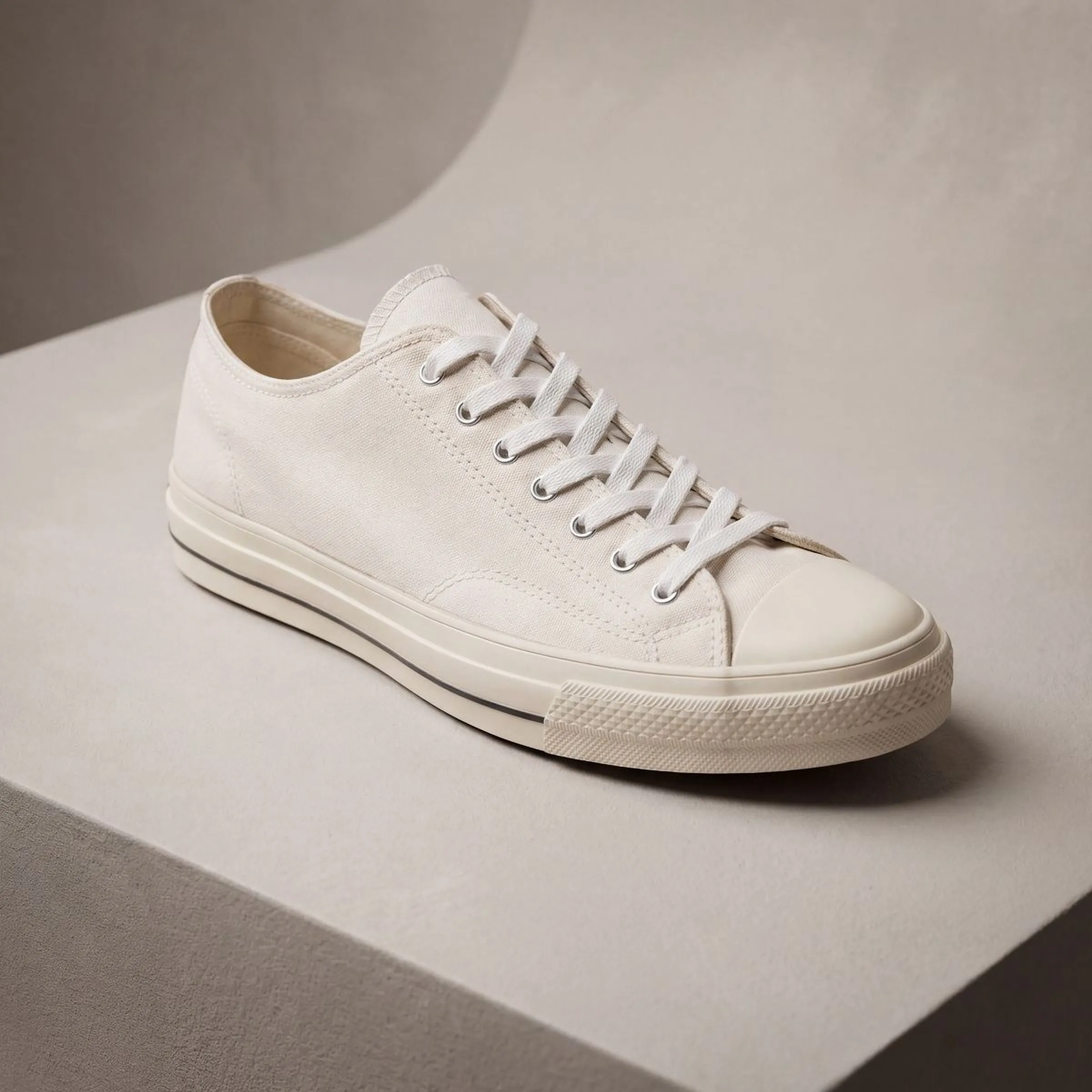 The same sneaker angled on a studio riser, showing the cupsole and toe cap