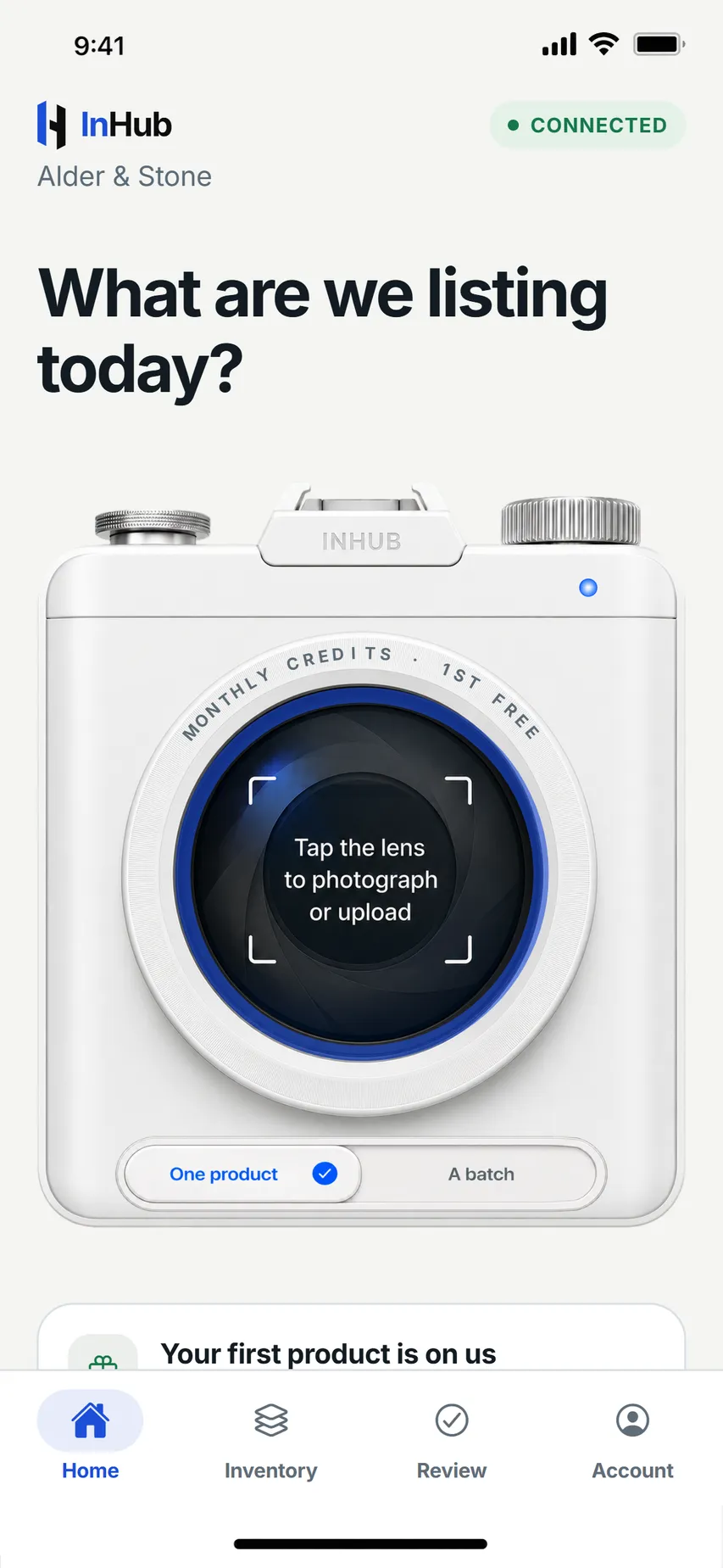 The InHub home screen: a white camera whose lens reads Tap the lens to photograph or upload, ringed by the monthly credits gauge, with a One product or A batch toggle beneath it