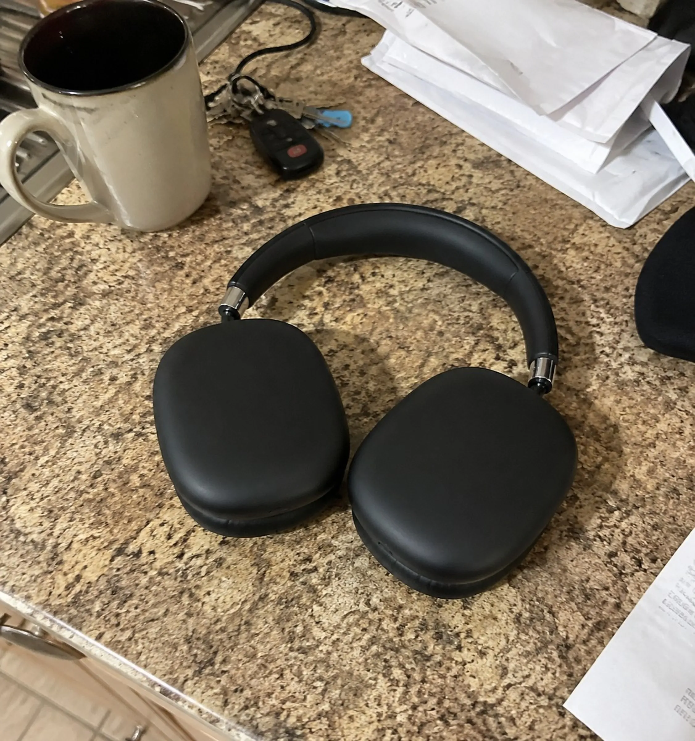 Wireless over-ear headphones photographed on a kitchen counter