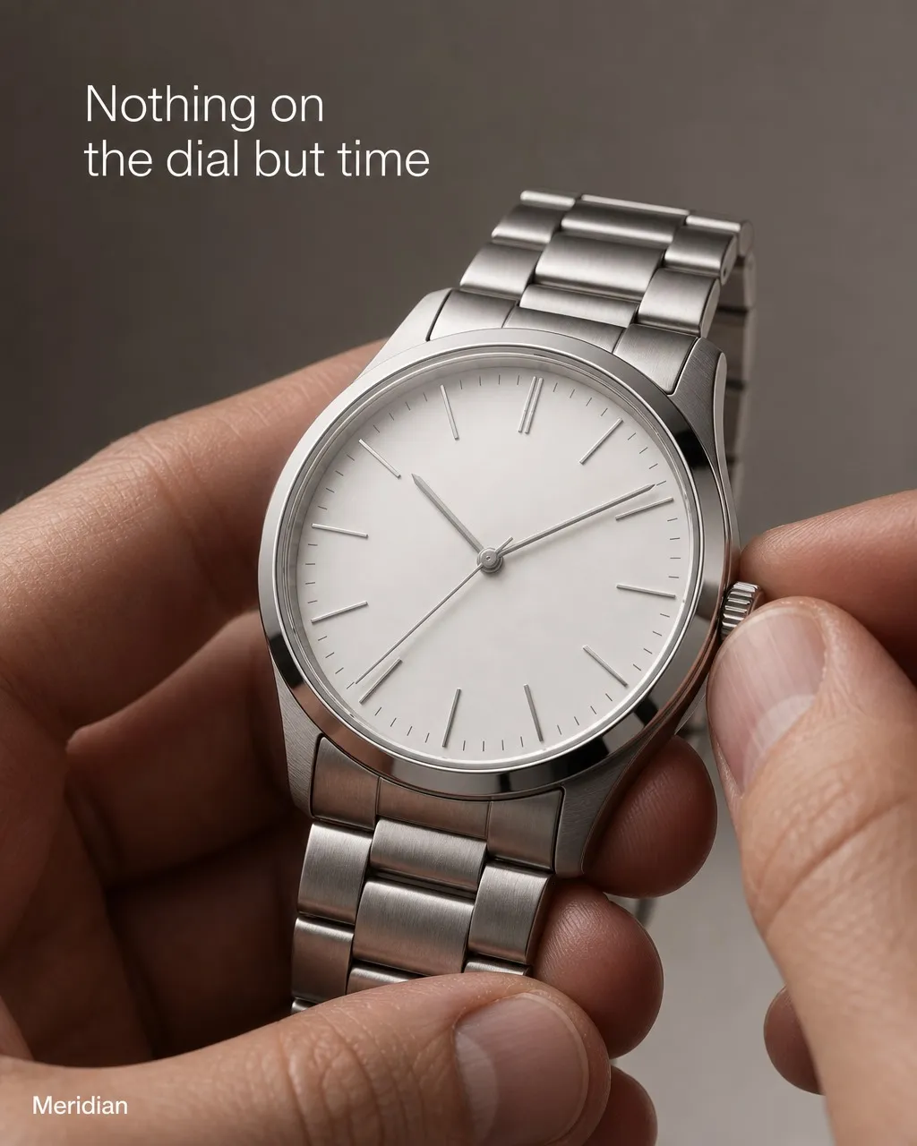 An ad for a minimalist steel watch held between two fingers, the headline set into the top of the photograph